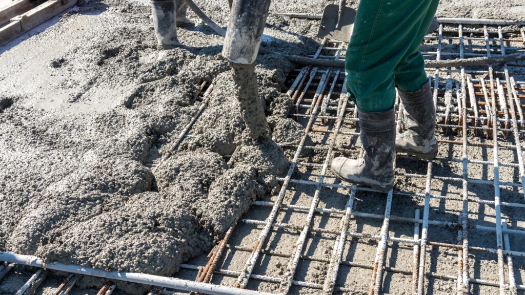 Pouring a residential concrete slab over steel reinforcement